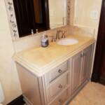 This bathroom vanity is sprayed with a taupe lacquer and finished with a silver glaze around the edges.  It features full extension drawer slides along with a 2 1/2" thick countertop with a double bull nose edge.