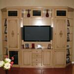 This entertainment center is sprayed with our taupe lacquer and hand brushed with our antique Vandyke brown glaze.  It features fluted columns, built in speakers, full extension drawers for DVD and CD storage, and corner shelves.  
