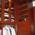 This Cherry custom closet fits wall to wall and floor to ceiling leaving no dead space whatsoever.  It features glass doors, thick closet poles, full extension drawers, along with cherry shelves.
