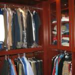 This Cherry custom closet fits wall to wall and floor to ceiling leaving no dead space whatsoever.  It features glass doors, thick closet poles, full extension drawers, along with cherry shelves.
